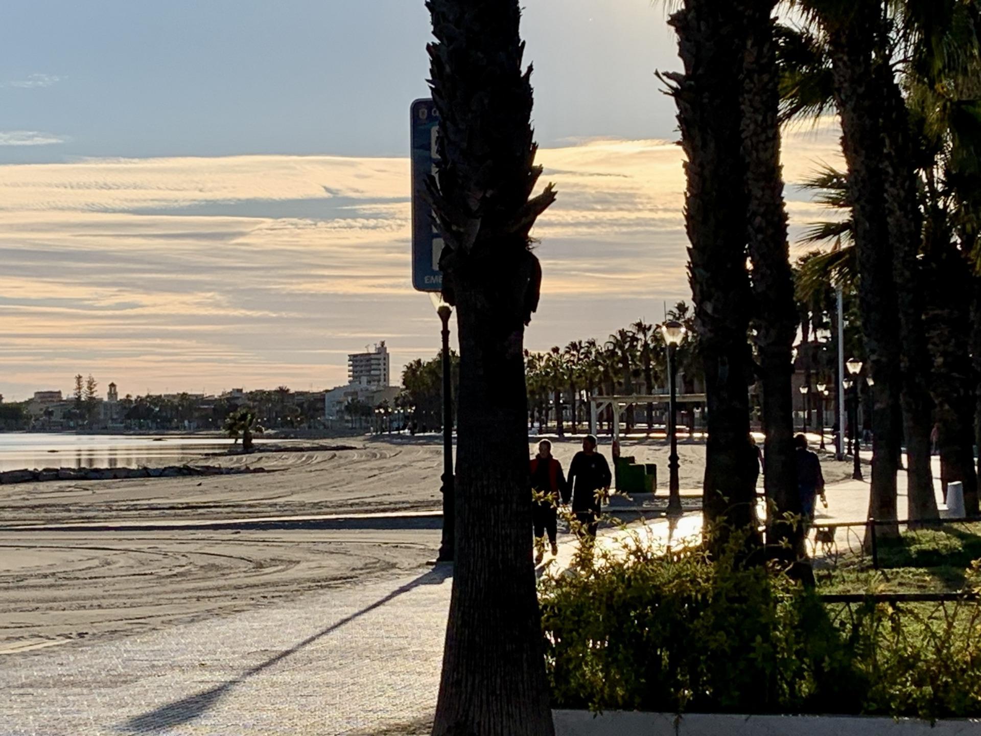 Sun-drenched beach promenade near exclusive new build villas with private pools in Los Alcázares, Murcia at sunset.