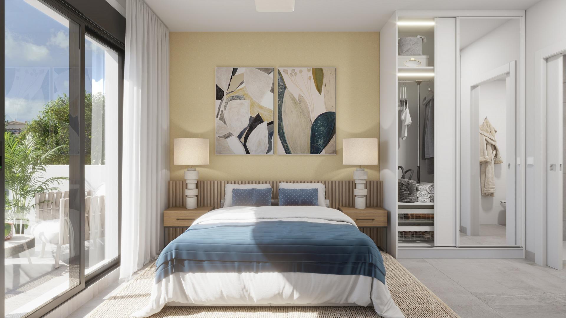 Bright, elegant bedroom with modern decor and garden views in exclusive new build villa near the beach in Los Alcázares, Murcia.
