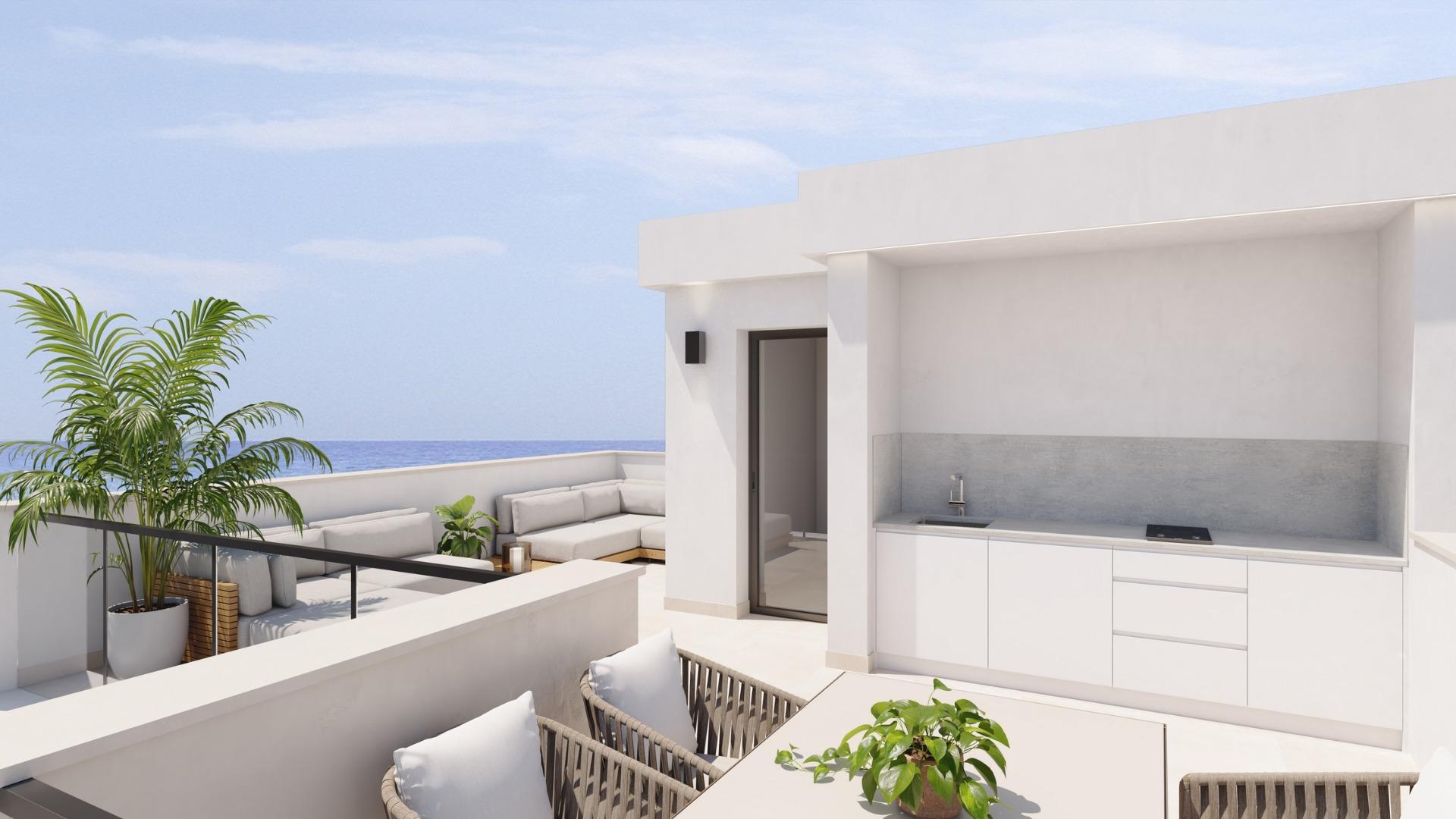 Bright terrace with modern outdoor kitchen and seating, exclusive new build villa just steps from the beach in Los Alcázares, Murcia