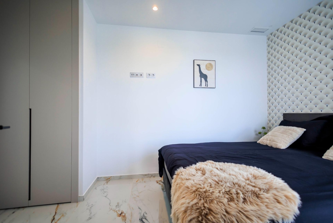 NEW-BUILD-VILLAS-IN-PILAR-DE-LA-HORADADA-ON-THE-GOLF-COURSE-17 Bright modern bedroom with elegant decor and marble flooring in new build villas in Pilar de la Horadada on the golf course