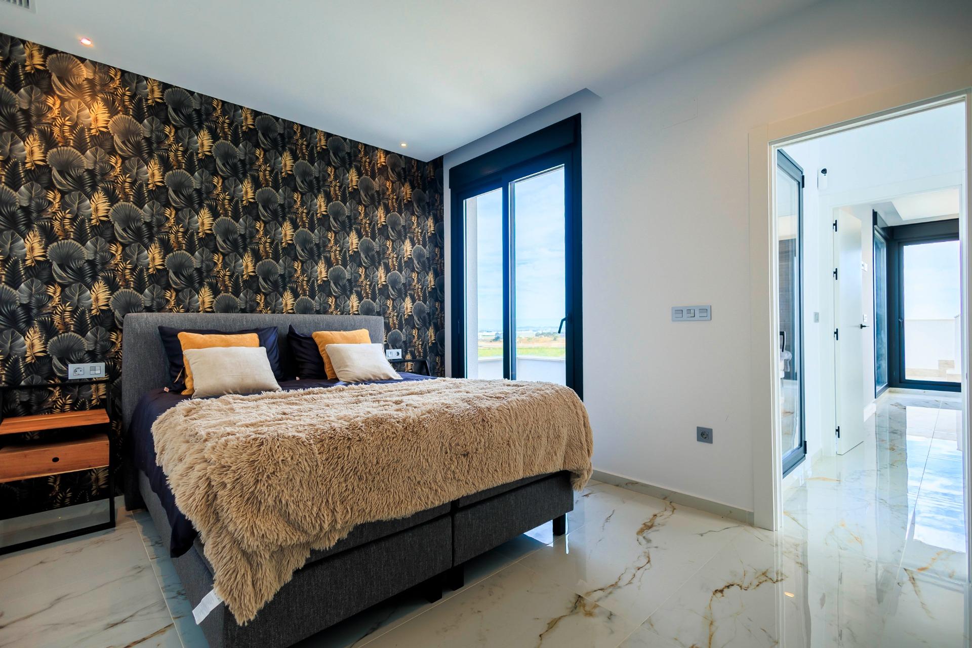NEW-BUILD-VILLAS-IN-PILAR-DE-LA-HORADADA-ON-THE-GOLF-COURSE-23 Bright modern bedroom with luxurious decor and golf course views in new build villas in Pilar de la Horadada