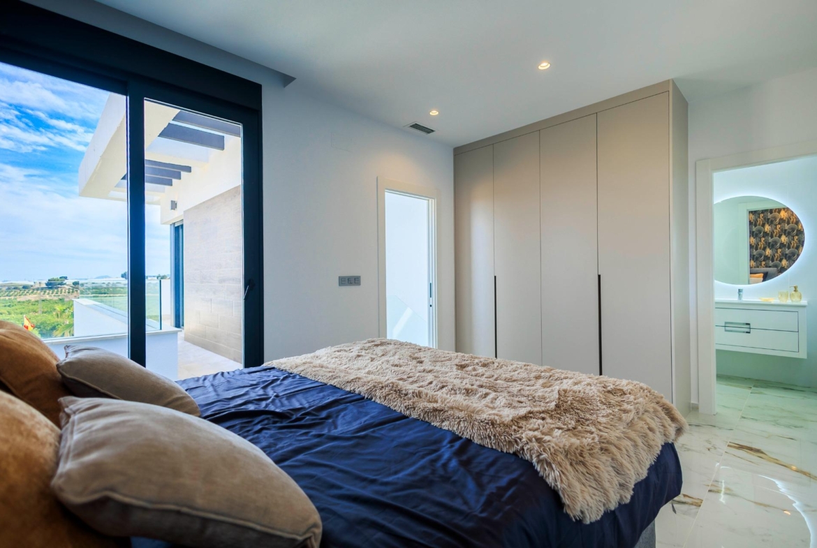 NEW-BUILD-VILLAS-IN-PILAR-DE-LA-HORADADA-ON-THE-GOLF-COURSE-24 Bright modern bedroom with plush bed and sleek built-in wardrobes in new build villa overlooking golf course in Pilar de la Horadada