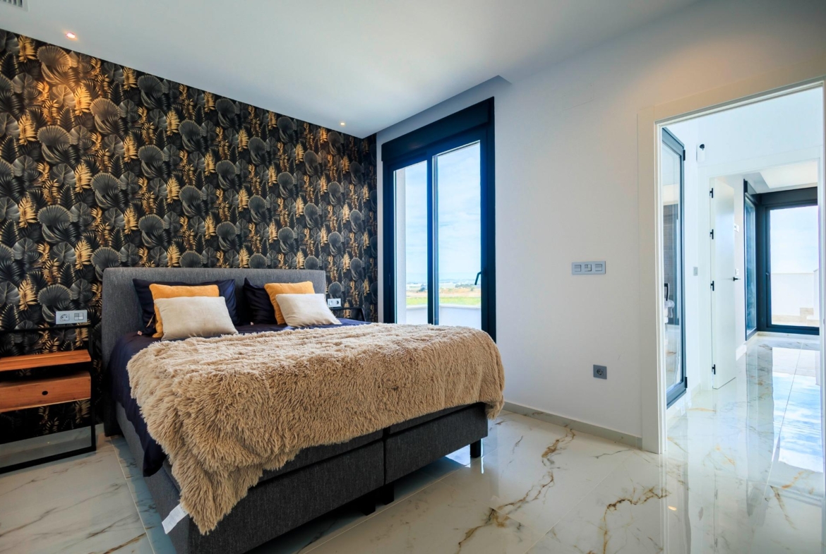 Modern bedroom with plush bedding, bold accent wall, and sunlit views in luxury new build villa in Pilar de la Horadada golf course