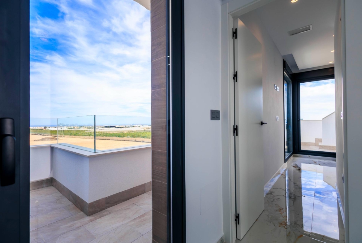 NEW-BUILD-VILLAS-IN-PILAR-DE-LA-HORADADA-ON-THE-GOLF-COURSE-35 Bright modern hallway with glossy marble floors and terrace overlooking golf course in new build villas in Pilar de la Horadada