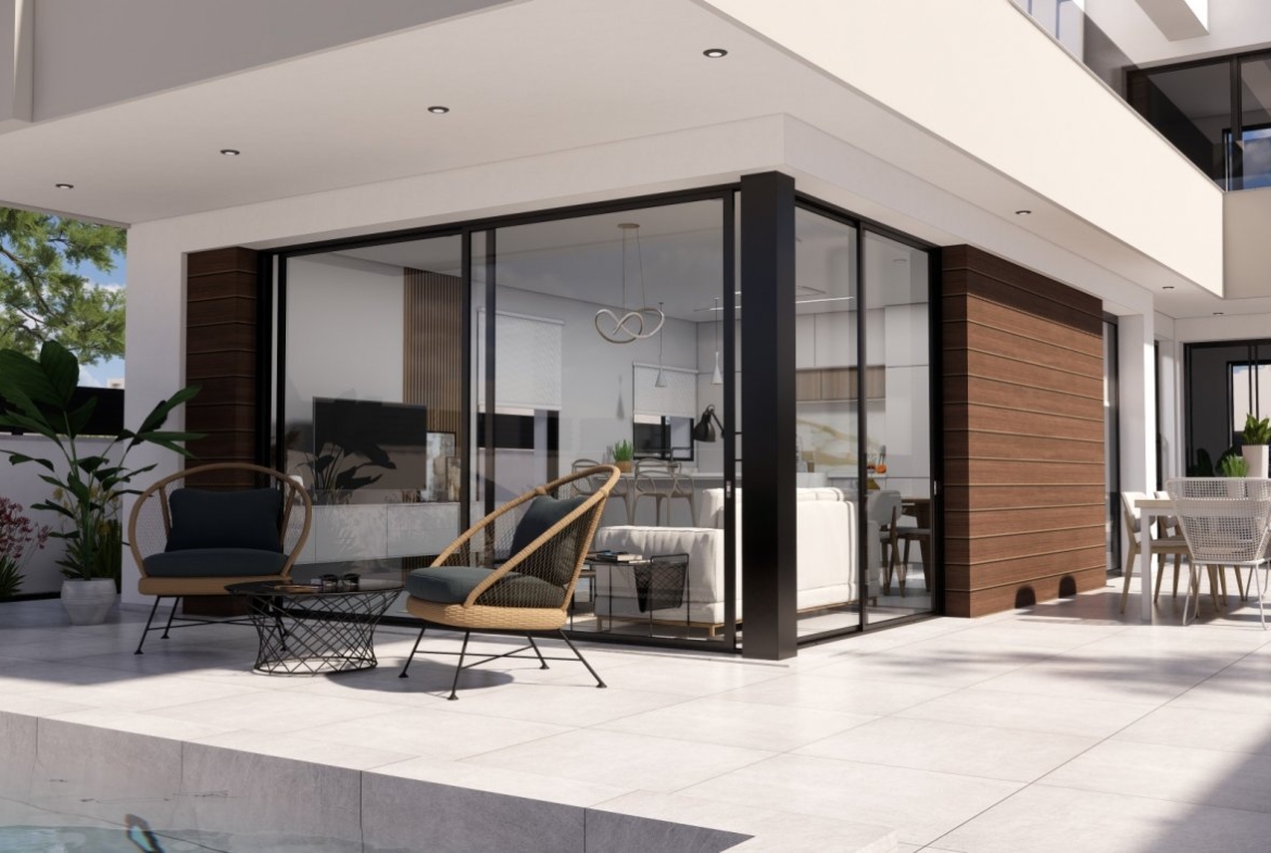 Spacious modern terrace with sleek lounge seating and dining area in new build villas on Pilar de la Horadada golf course.