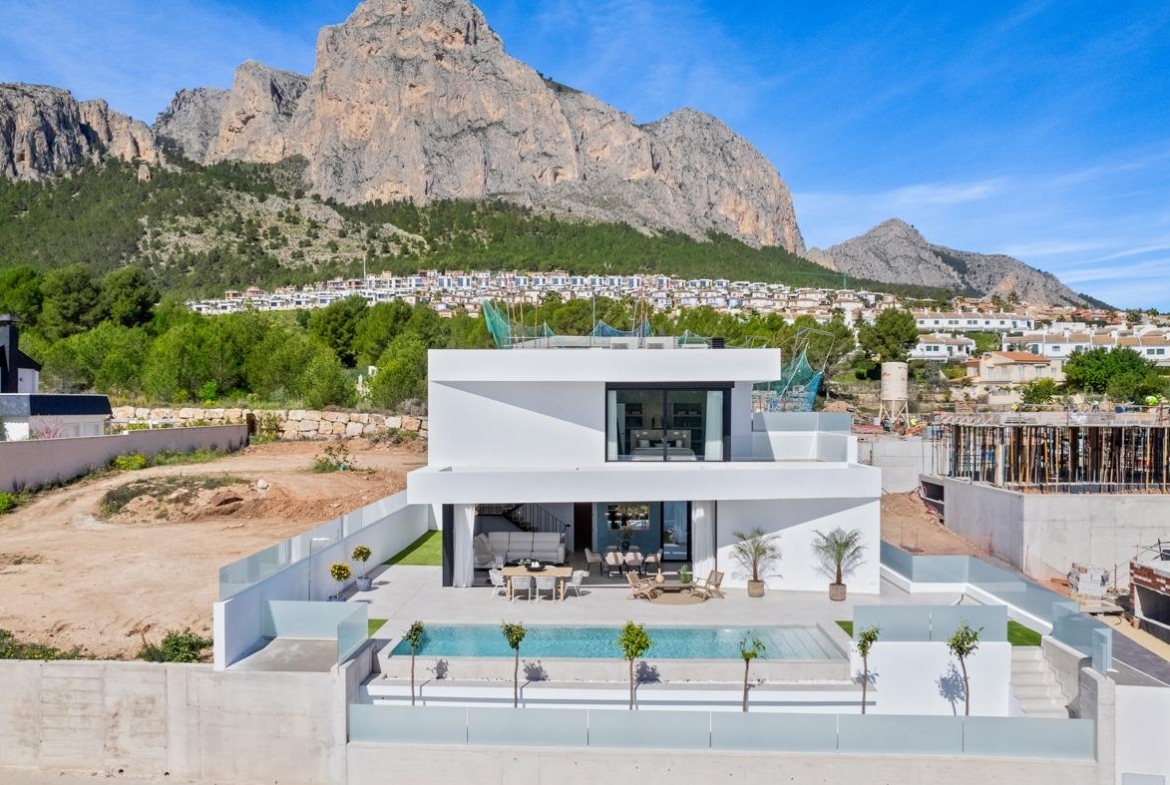 Stunning modern 3-bedroom villa with private pool and spacious terrace set against dramatic mountain backdrop in Polop, Costa Blanca.