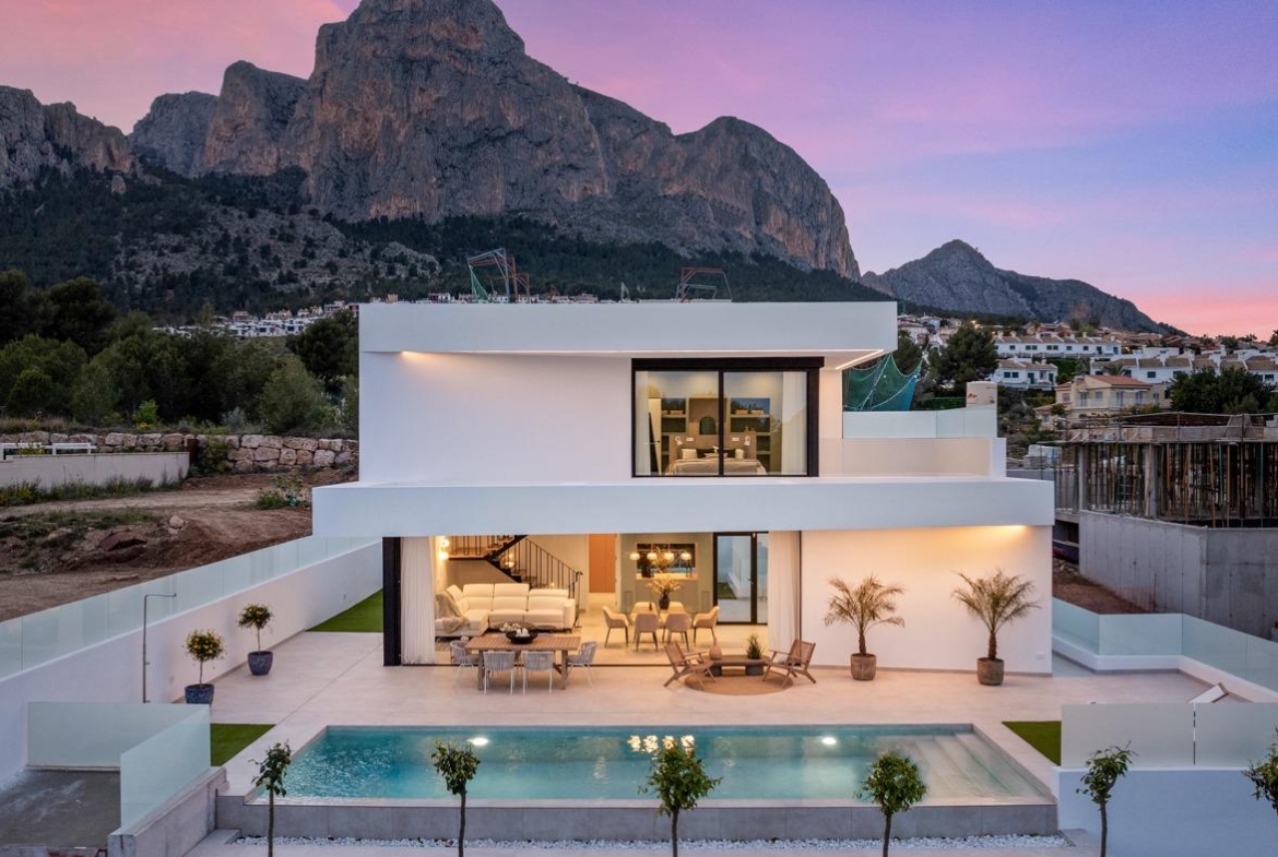 Modern 3 bedroom villa in Polop, Costa Blanca with private pool, spacious sunlit terrace, and stunning mountain backdrop at sunset.