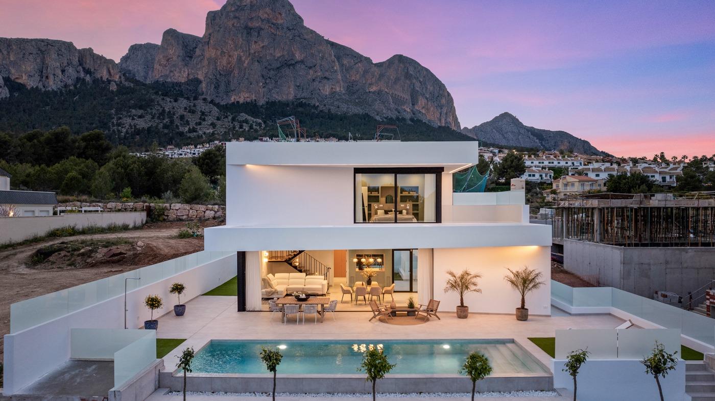 Modern 3 bedroom villa in Polop, Costa Blanca with private pool, spacious sunlit terrace, and stunning mountain backdrop at sunset.