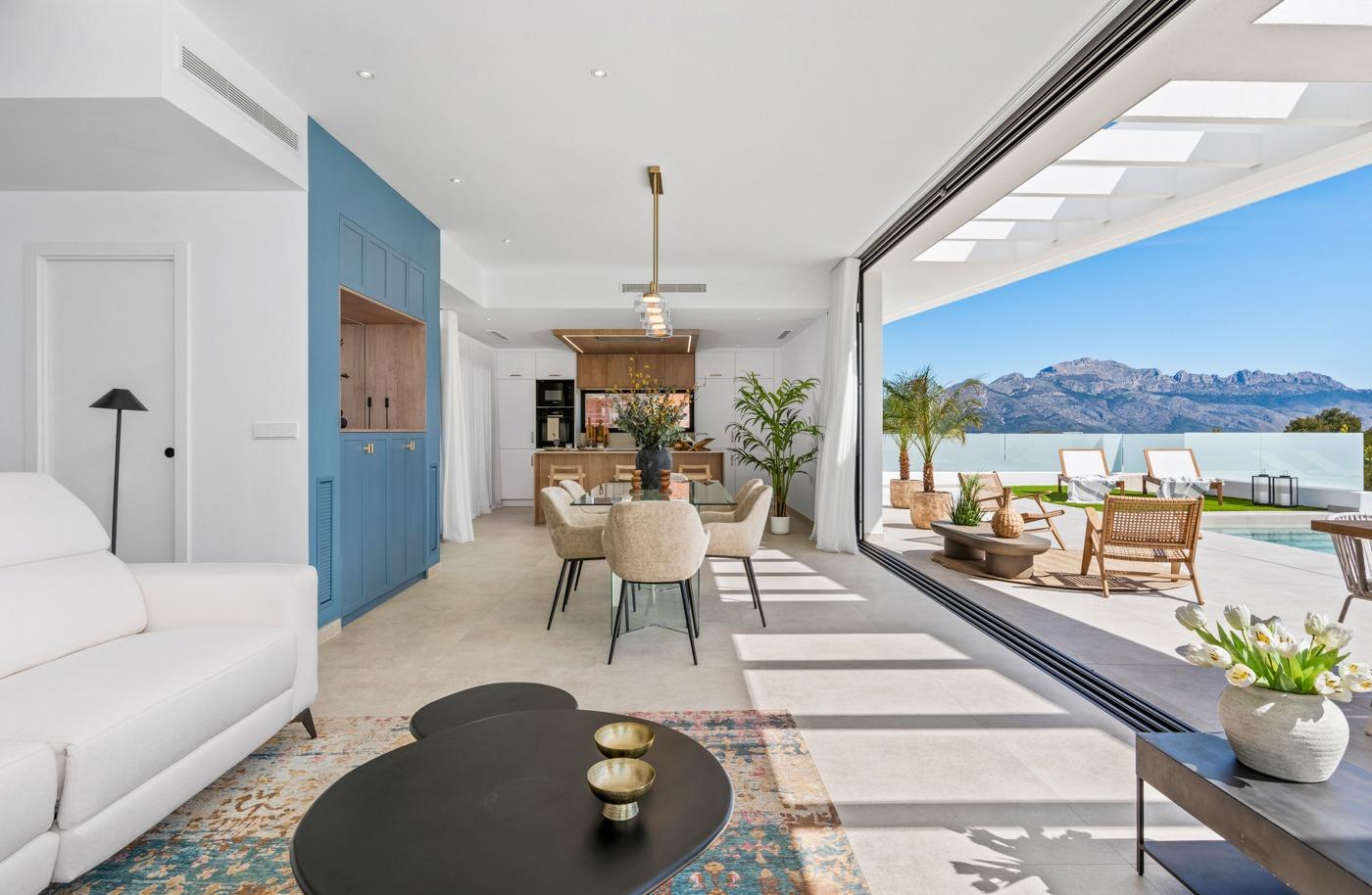 Bright open-plan living and dining area with modern kitchen, flowing to sun-drenched terrace and private pool in Polop villa.