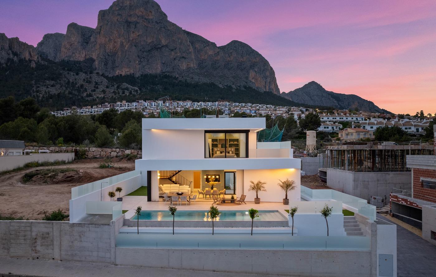 Modern 3-bedroom villa in Polop with sleek private pool, open terraces, and dramatic mountain backdrop at sunset.