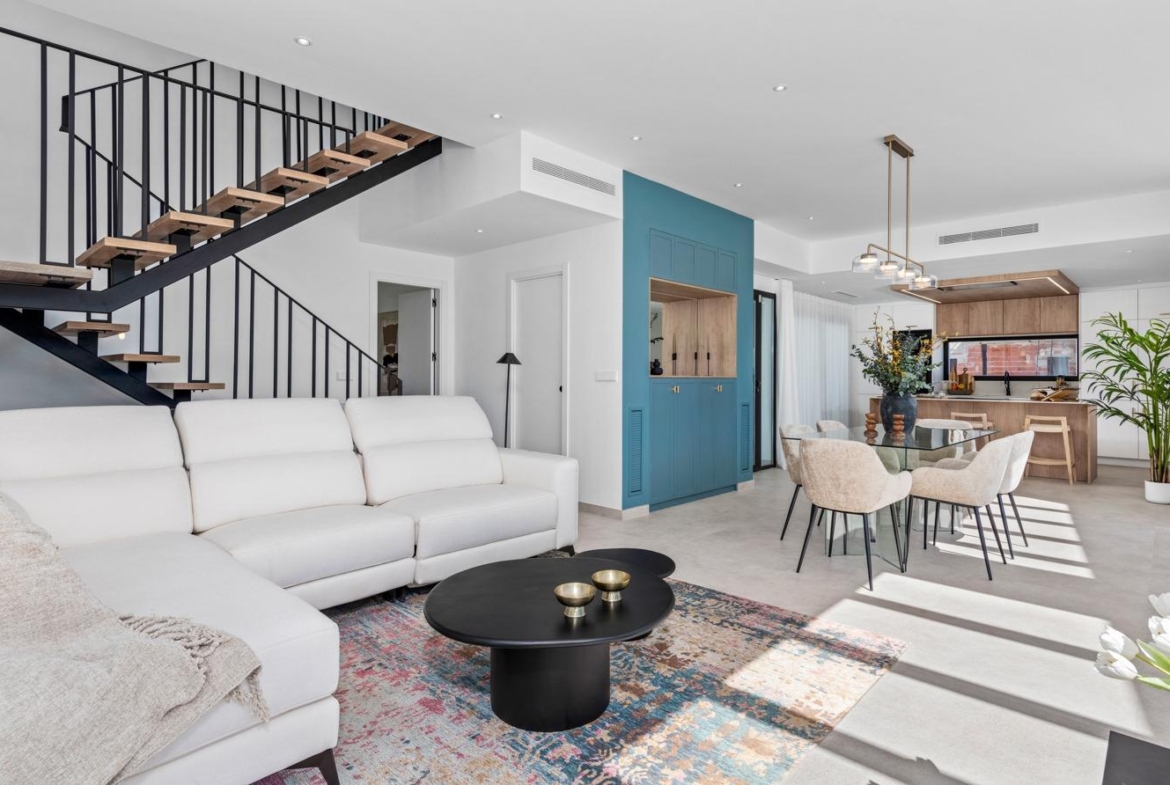 Bright and spacious open-plan living and dining area with modern staircase in luxury 3-bedroom villa in Polop, Costa Blanca