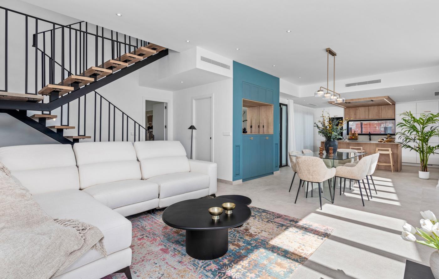 Bright and spacious open-plan living and dining area with modern staircase in luxury 3-bedroom villa in Polop, Costa Blanca