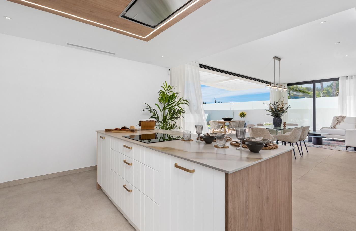 Bright modern open-plan kitchen and dining area in a new build 3-bedroom villa in Polop, Costa Blanca.