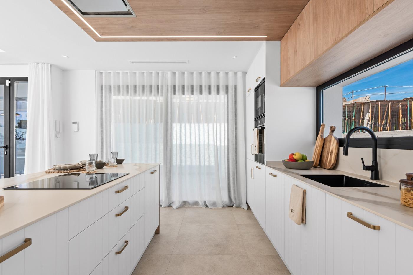 Bright modern kitchen with sleek cabinetry and wood accents in a luxury 3-bedroom villa in Polop, Costa Blanca.