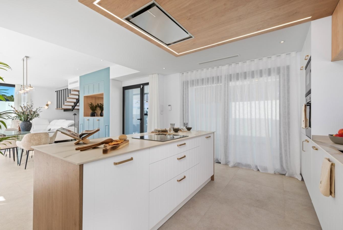 Bright modern open-plan kitchen with sleek island in luxury 3 bedroom villa in Polop, Costa Blanca.