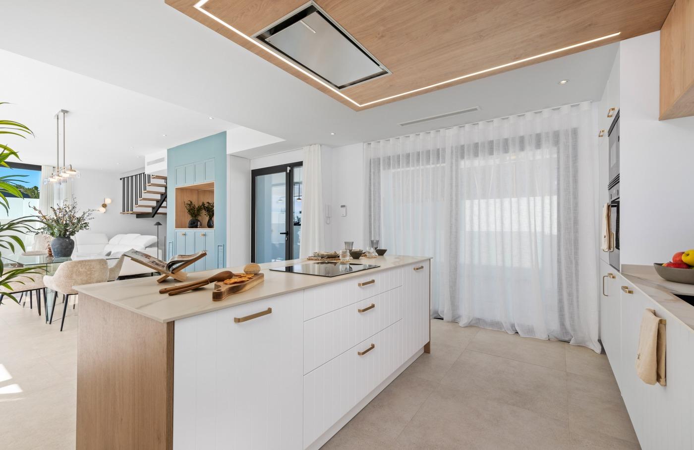 Bright modern open-plan kitchen with sleek island in luxury 3 bedroom villa in Polop, Costa Blanca.