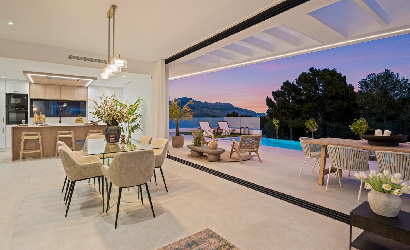 Spacious open-plan dining and kitchen area flowing to a terrace with private pool and mountain views in a modern 3-bedroom villa in Polop, Costa Blanca