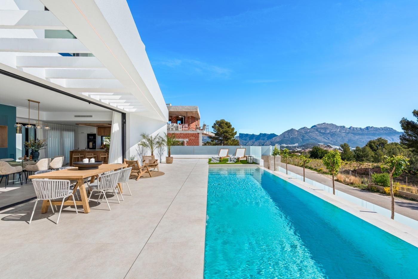 Spacious sun-drenched terrace with private pool and panoramic mountain views at luxury 3-bedroom villa in Polop, Costa Blanca