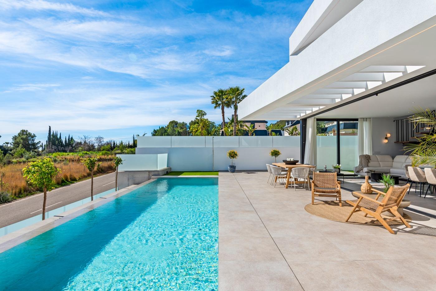 Modern 3-bedroom villa in Polop with a sun-drenched terrace, private pool, and stylish outdoor seating overlooking open countryside.