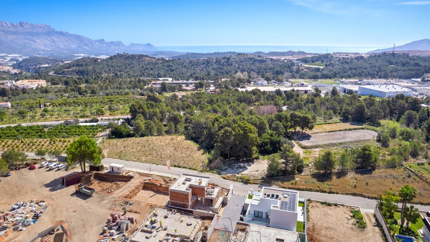 Aerial view of a modern new build 3 bedroom villa with spacious terraces in a peaceful Polop, Costa Blanca landscape.