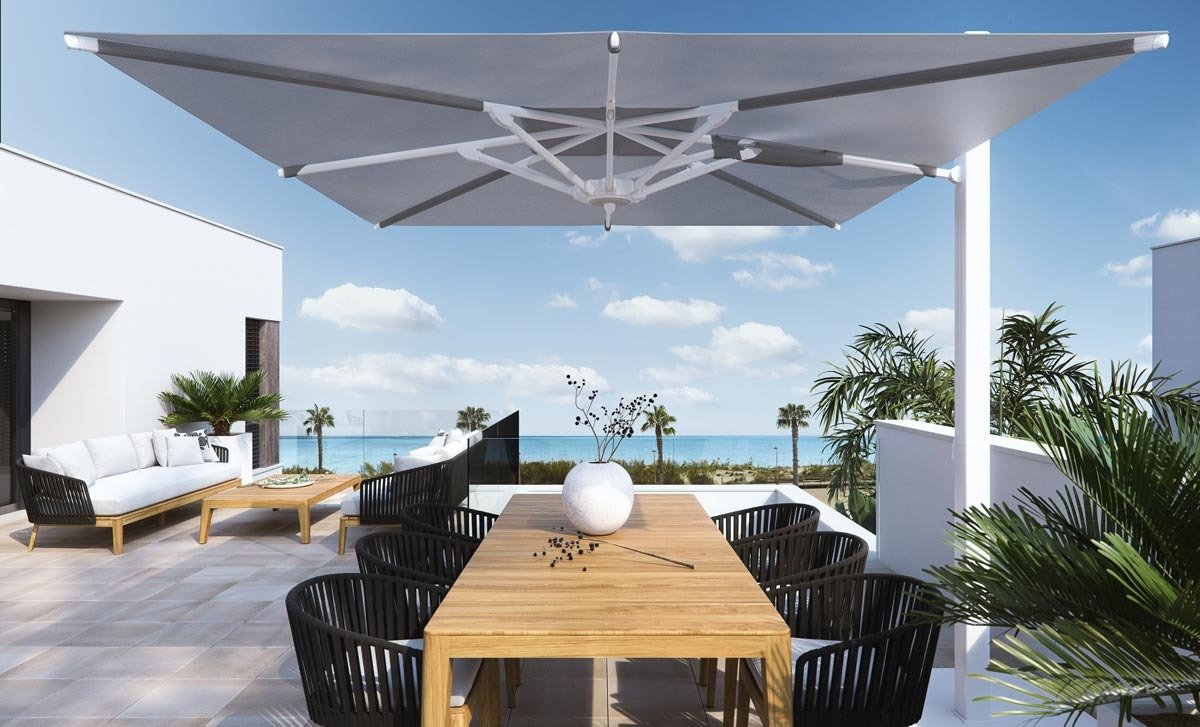 Sun-drenched terrace with modern dining area and lounge overlooking panoramic sea views at new build villas in Torre de la Horadada