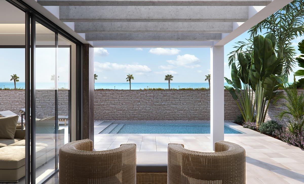 Modern terrace with wicker seating, sleek pool, and partial sea view at new build villas in Torre de la Horadada.