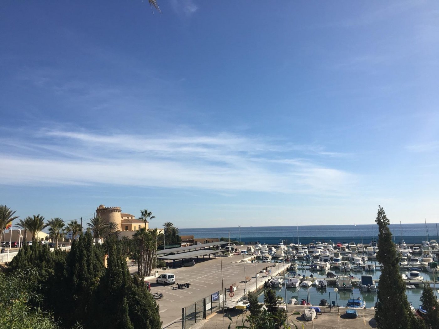 Panoramic sea view over marina with luxury new build villas in Torre de la Horadada under clear blue sky