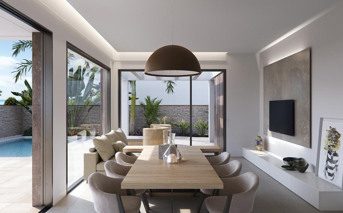 Bright, modern dining area with sliding glass doors opening to a private pool in new build villas in Torre de la Horadada