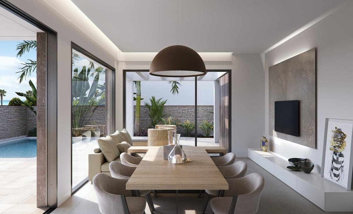 Bright, modern dining area with sliding glass doors opening to a private pool in new build villas in Torre de la Horadada