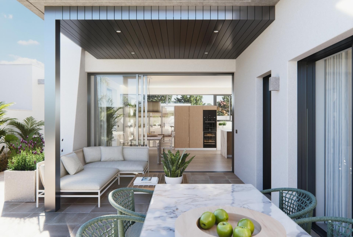 Spacious sun-drenched terrace with modern seating and dining area in a new built villa on a floor.