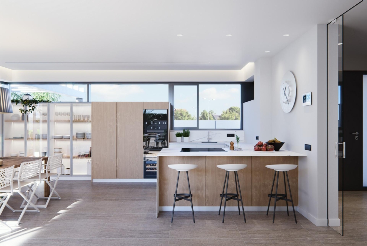 Bright, modern kitchen with sleek wood cabinetry and breakfast bar in a newly built villa on a floor, sunlit and airy.