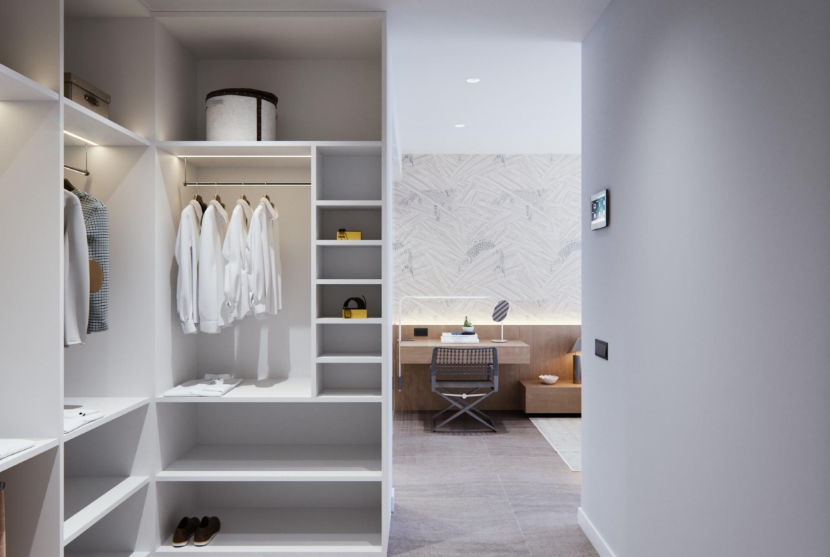 Bright, modern walk-in closet leading to a sleek workspace in a new built villa on a floor.