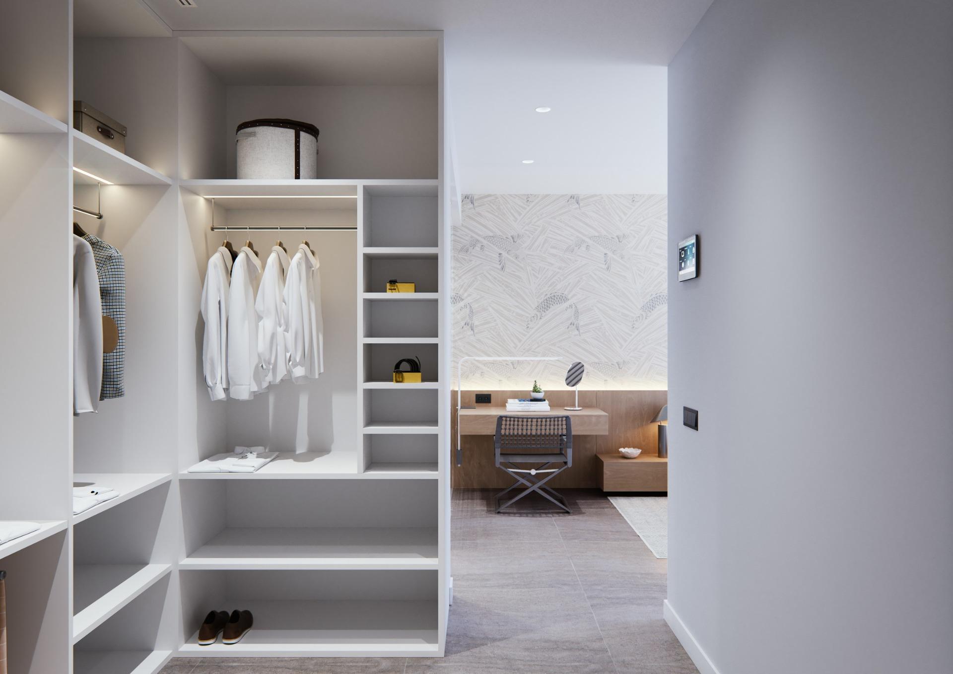 Bright, modern walk-in closet leading to a sleek workspace in a new built villa on a floor.