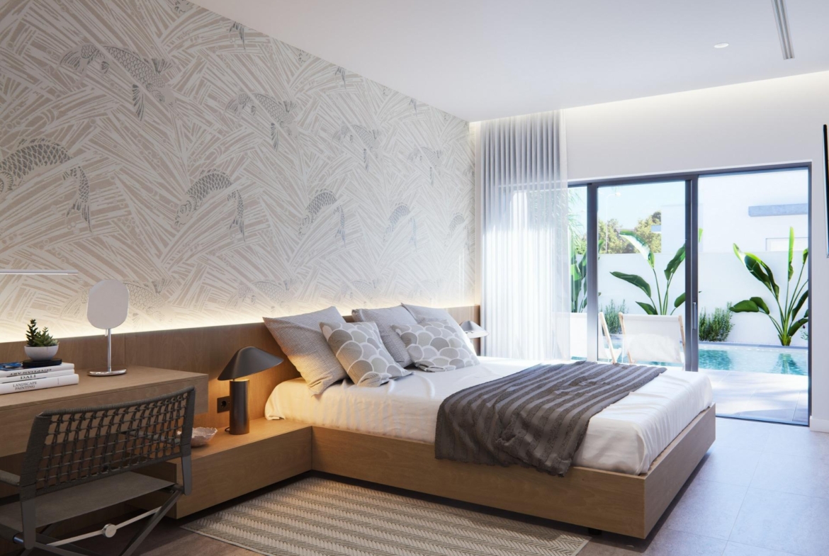 Sunlit, modern bedroom in new built villa on a floor with elegant decor and sliding doors opening to a private pool terrace.