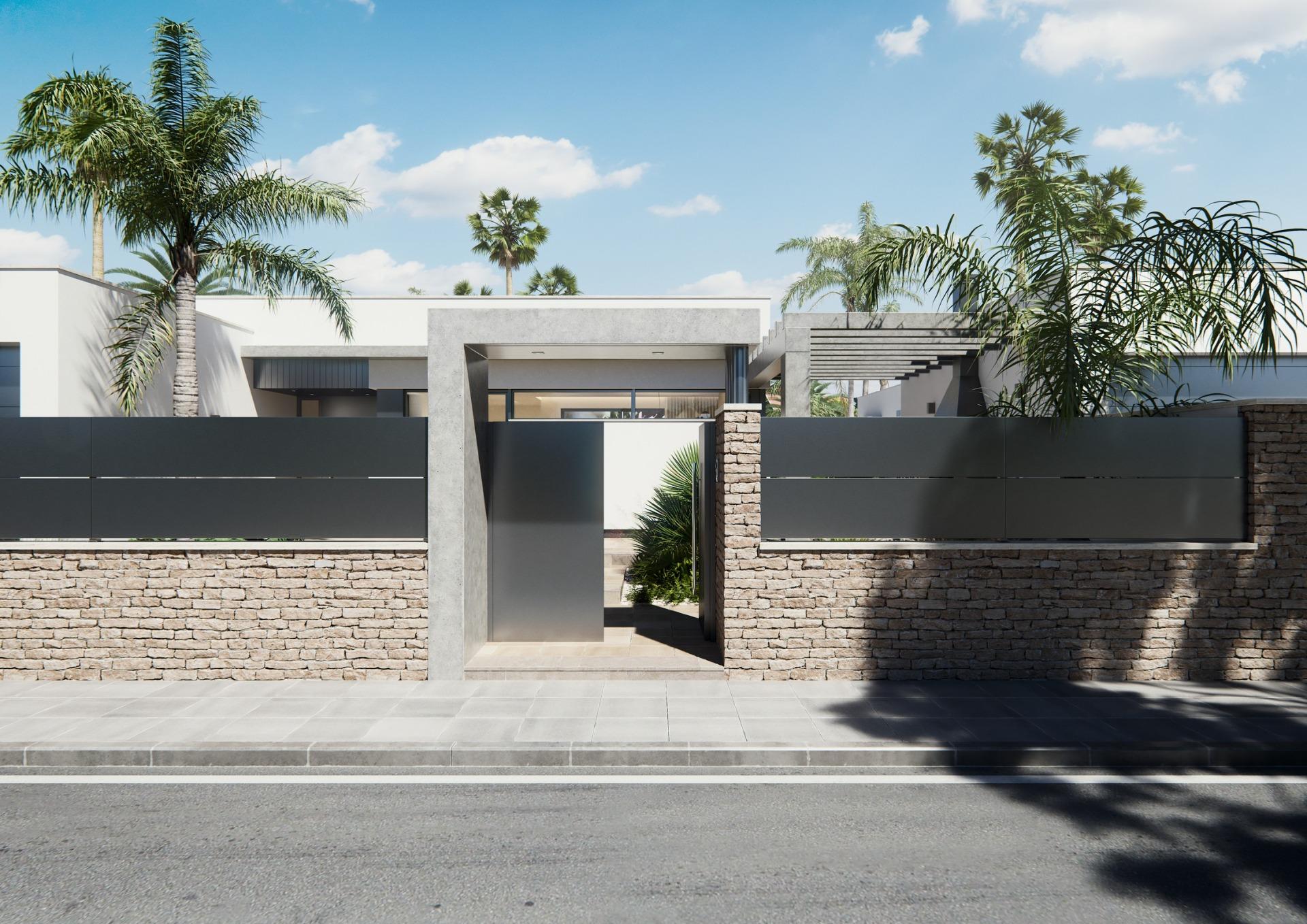 Modern new built villa entrance on a floor with sleek stone walls, metal gates, and lush tropical landscaping under a clear sky