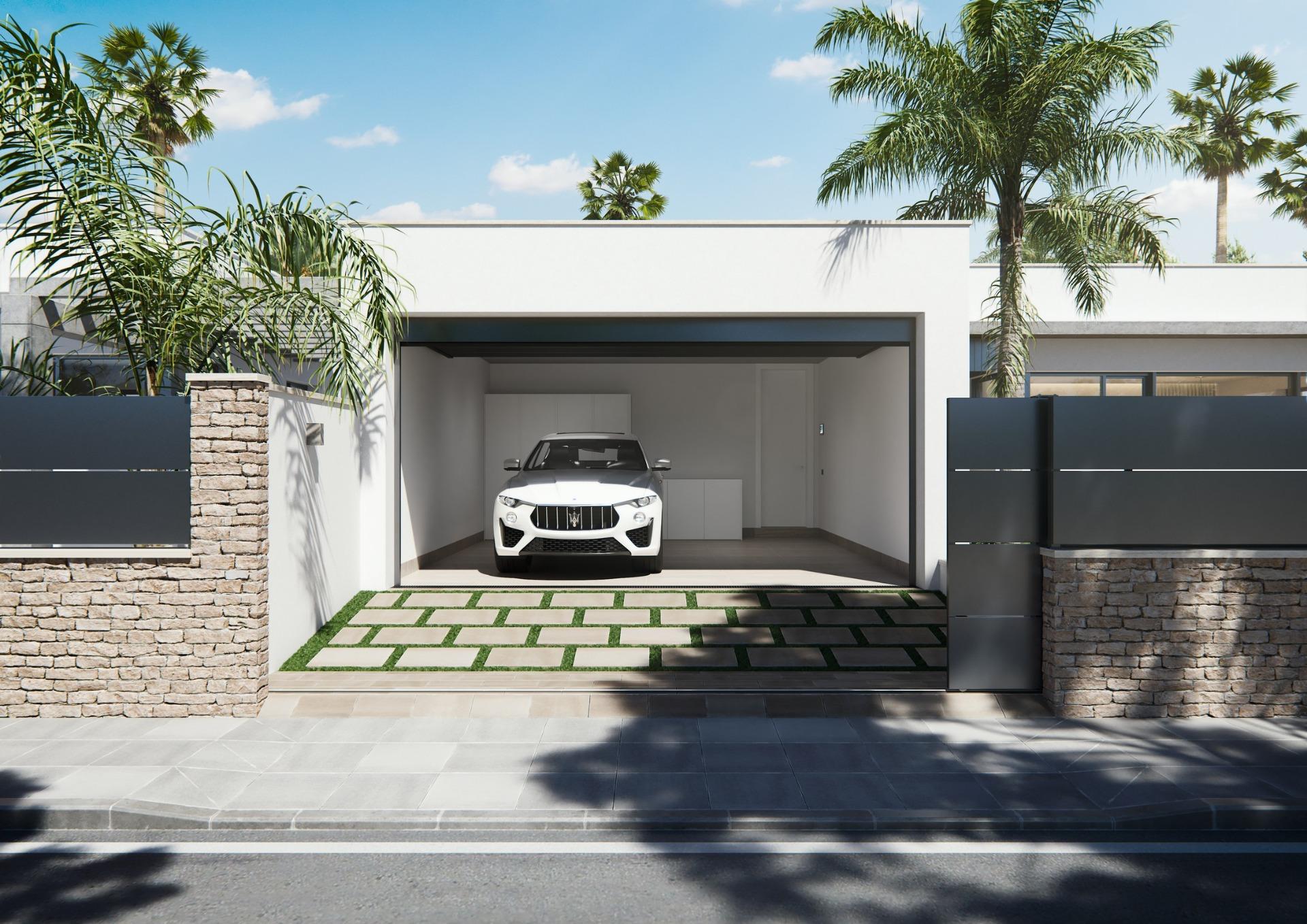Modern new built villa on a floor with sleek garage, lush palm trees, and a stylish stone and metal gated entrance.