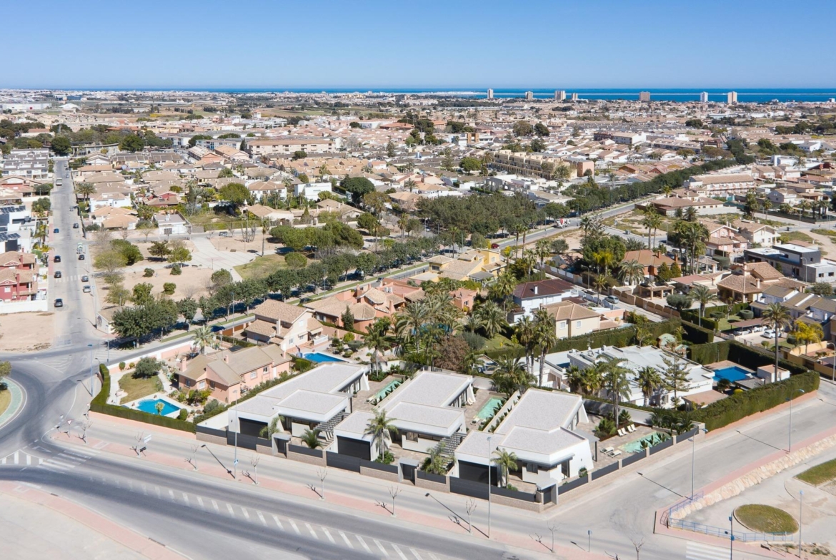 Aerial view of elegant new built villa on a floor with modern architecture and landscaped surroundings in a sunny neighborhood.