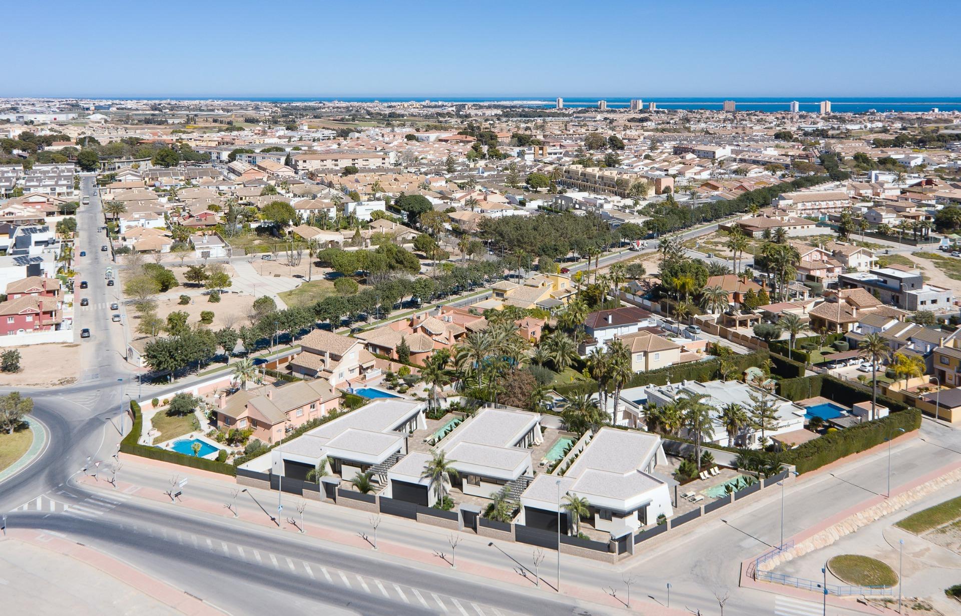 Aerial view of elegant new built villa on a floor with modern architecture and landscaped surroundings in a sunny neighborhood.