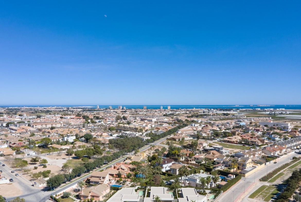 Stunning aerial view of new built villa on a floor with modern architecture and spacious layout in a vibrant coastal town