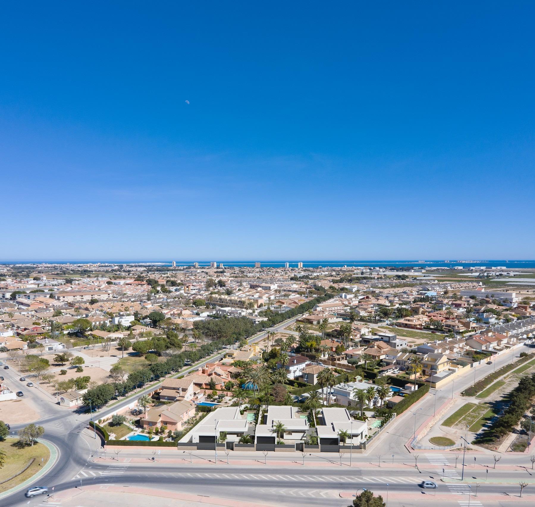 Stunning aerial view of new built villa on a floor with modern architecture and spacious layout in a vibrant coastal town