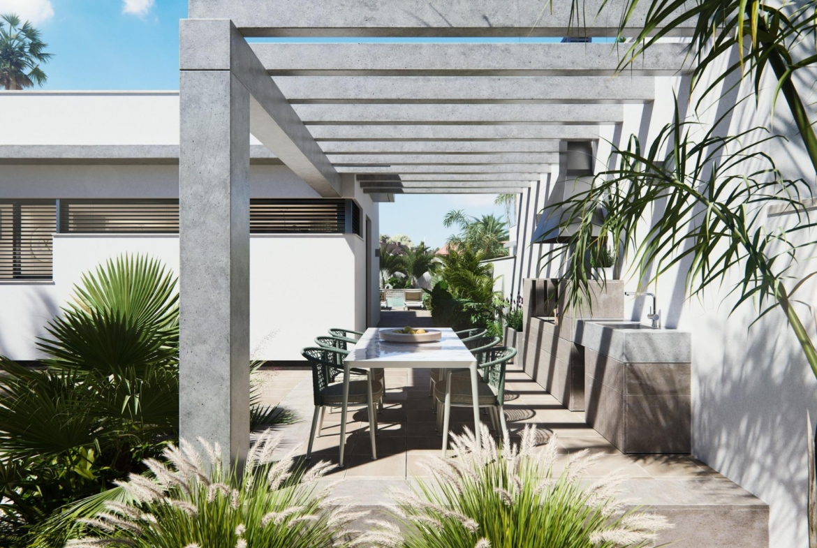 Modern new built villa on a floor with elegant shaded outdoor dining terrace surrounded by lush greenery and tropical plants