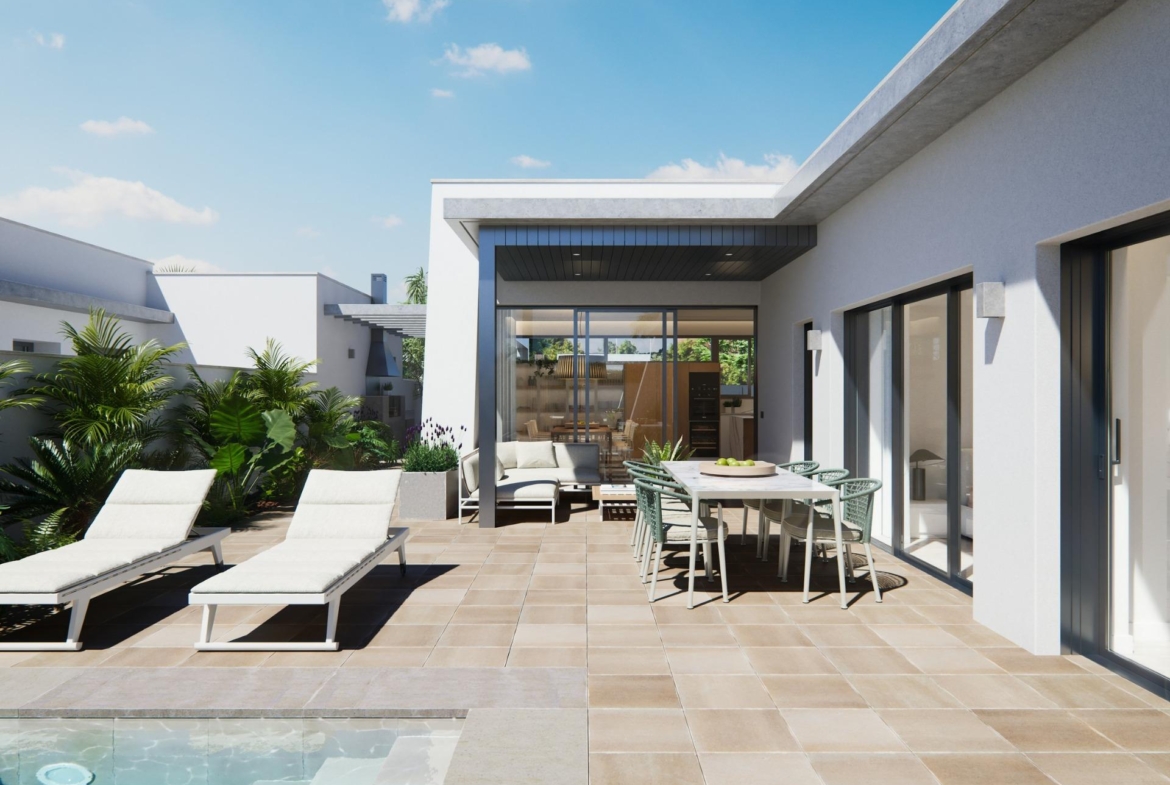 Sun-drenched terrace with modern outdoor dining and loungers overlooking pool at a new built villa on a floor.