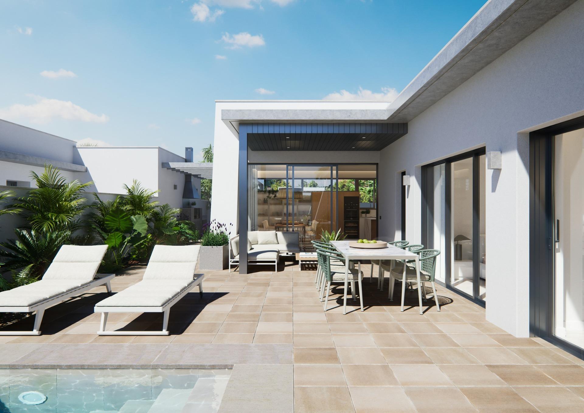 Sun-drenched terrace with modern outdoor dining and loungers overlooking pool at a new built villa on a floor.