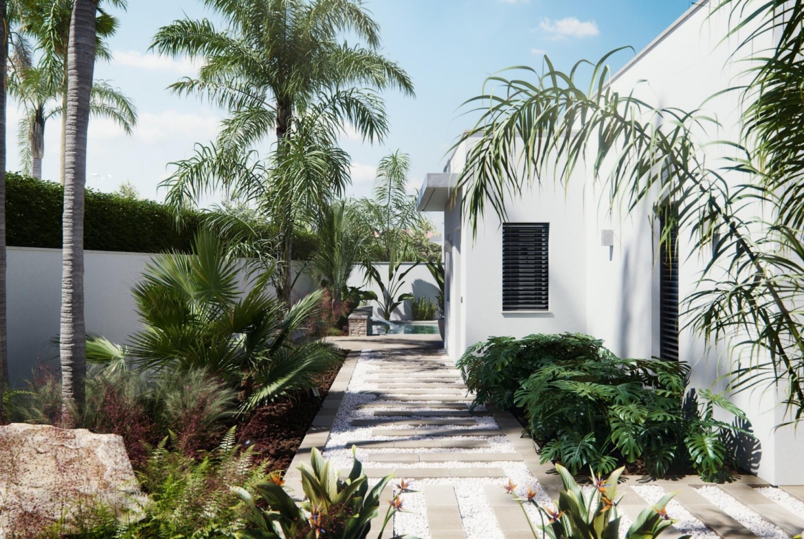 Lushly landscaped pathway alongside the sleek, modern new built villa on a floor, framed by palm trees and vibrant greenery