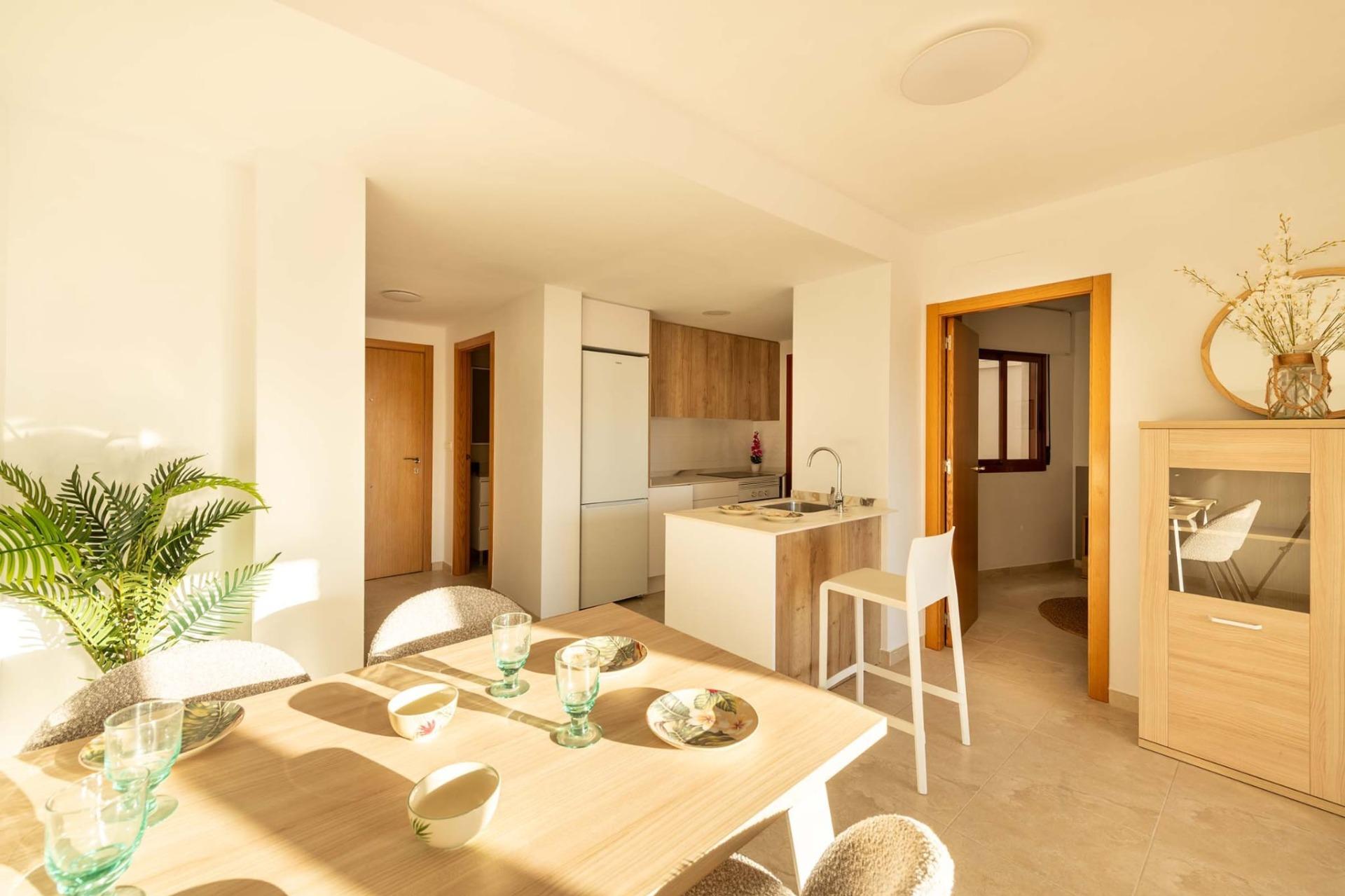 Bright open-plan kitchen and dining area with modern finishes in affordable new build 1-bedroom apartment in Avileses, Murcia.