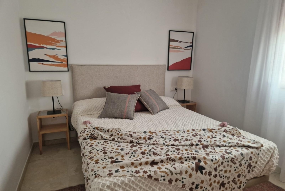 Bright, cozy bedroom with modern decor in an affordable new build studio apartment in Avileses, Murcia.