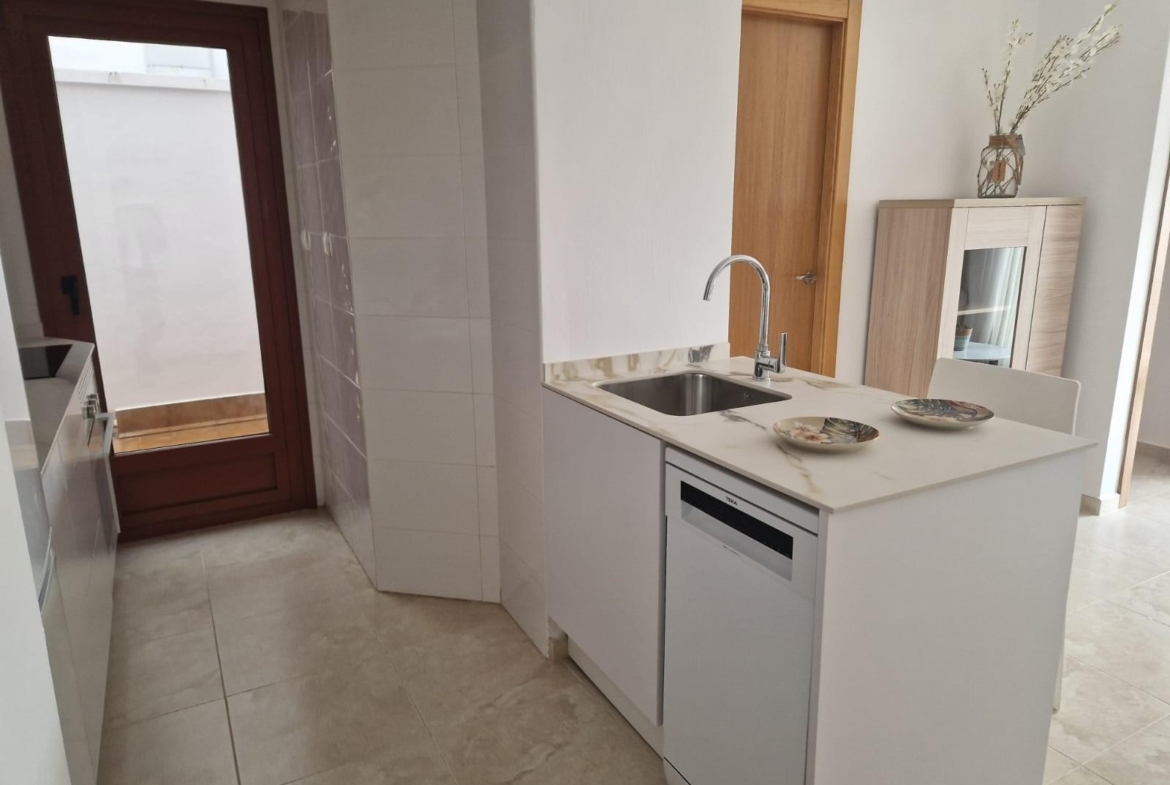 Modern bright kitchen with sleek island and marble countertops in affordable new build 1-bedroom apartment in Avileses, Murcia