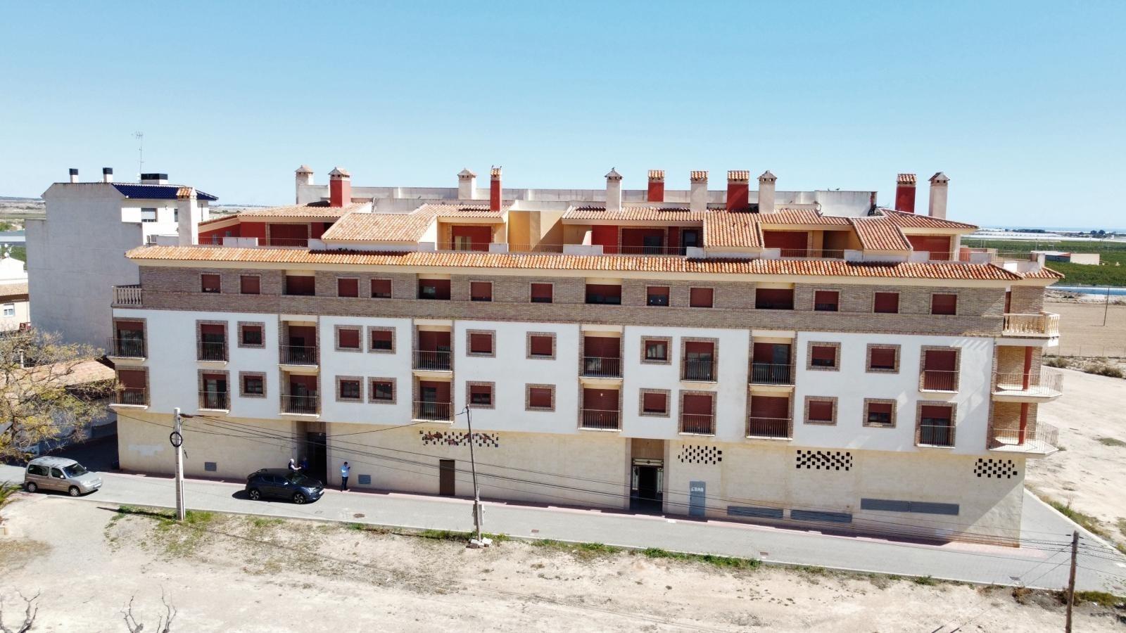 Modern new build studio apartment complex with bright terracotta roofs and spacious balconies in Avileses, Murcia.