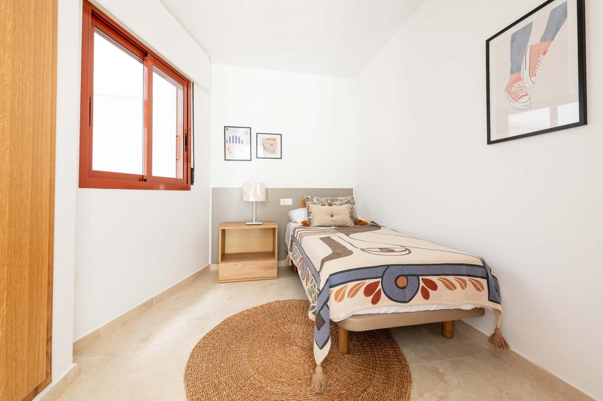 Bright, minimalist new build studio apartment bedroom with natural light and tasteful decor in Avileses, Murcia.