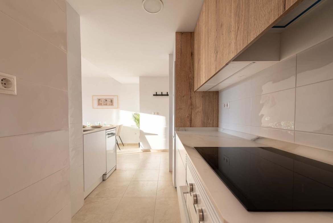 Bright modern kitchen with sleek wood cabinetry in affordable new build 1-bedroom apartment, Avileses, Murcia